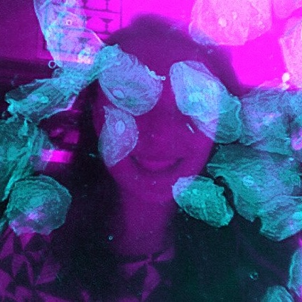 a merged photo with the author's face in magenta, overlaid by an image of her cheek cells in cyan